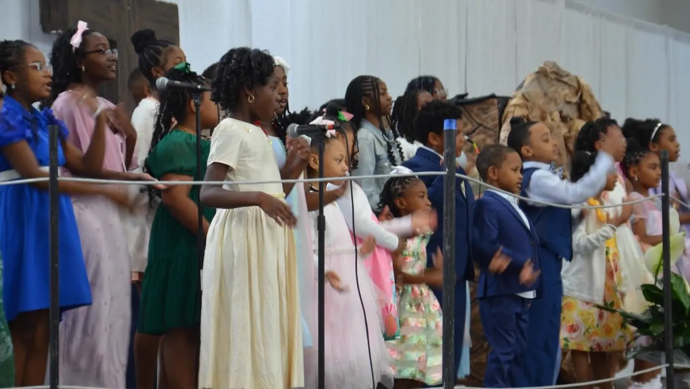 Children singing on stage during service