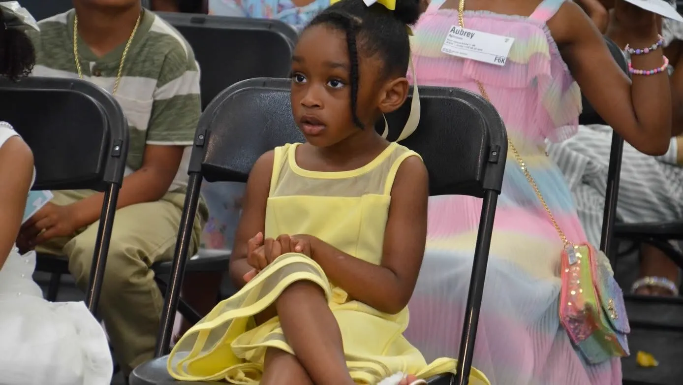 Little girl in yellow dress at a kids event