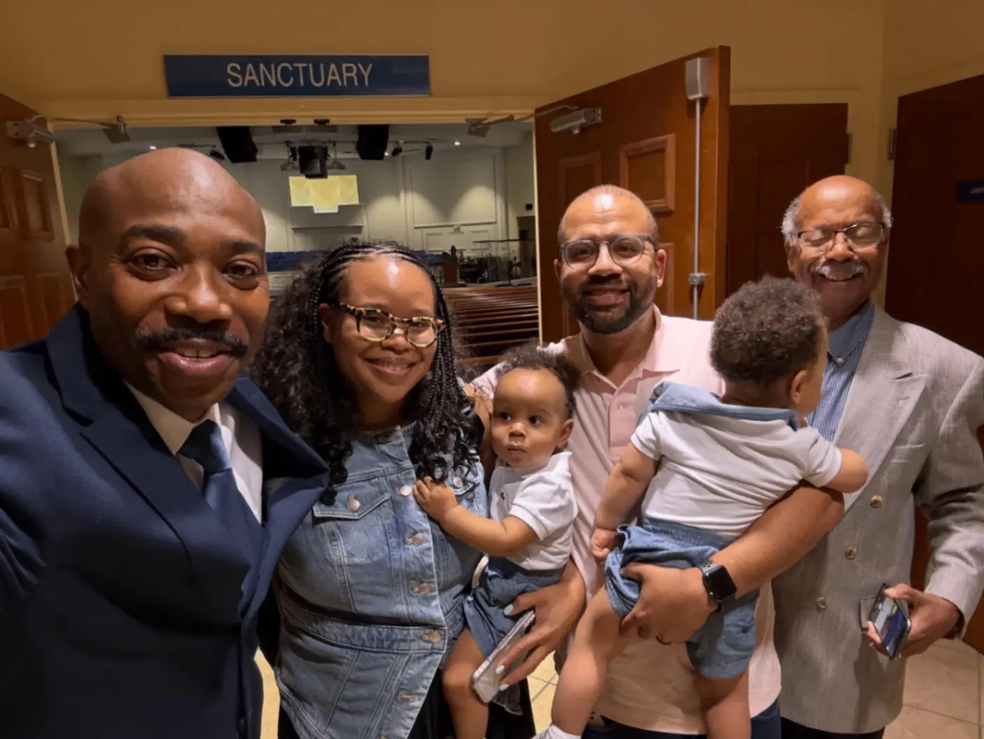 Pastor taking a selfie with a family outside the sanctuary