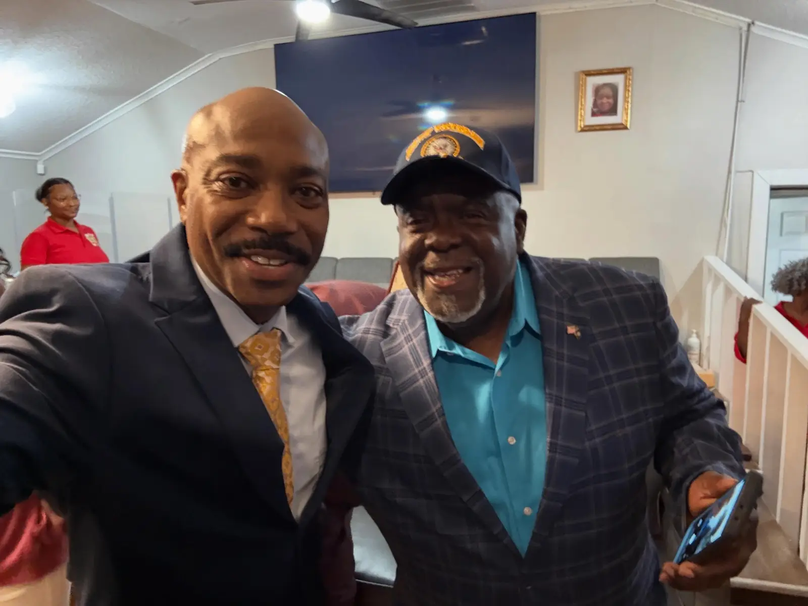 Pastor posing for a selfie with a church member in the sanctuary
