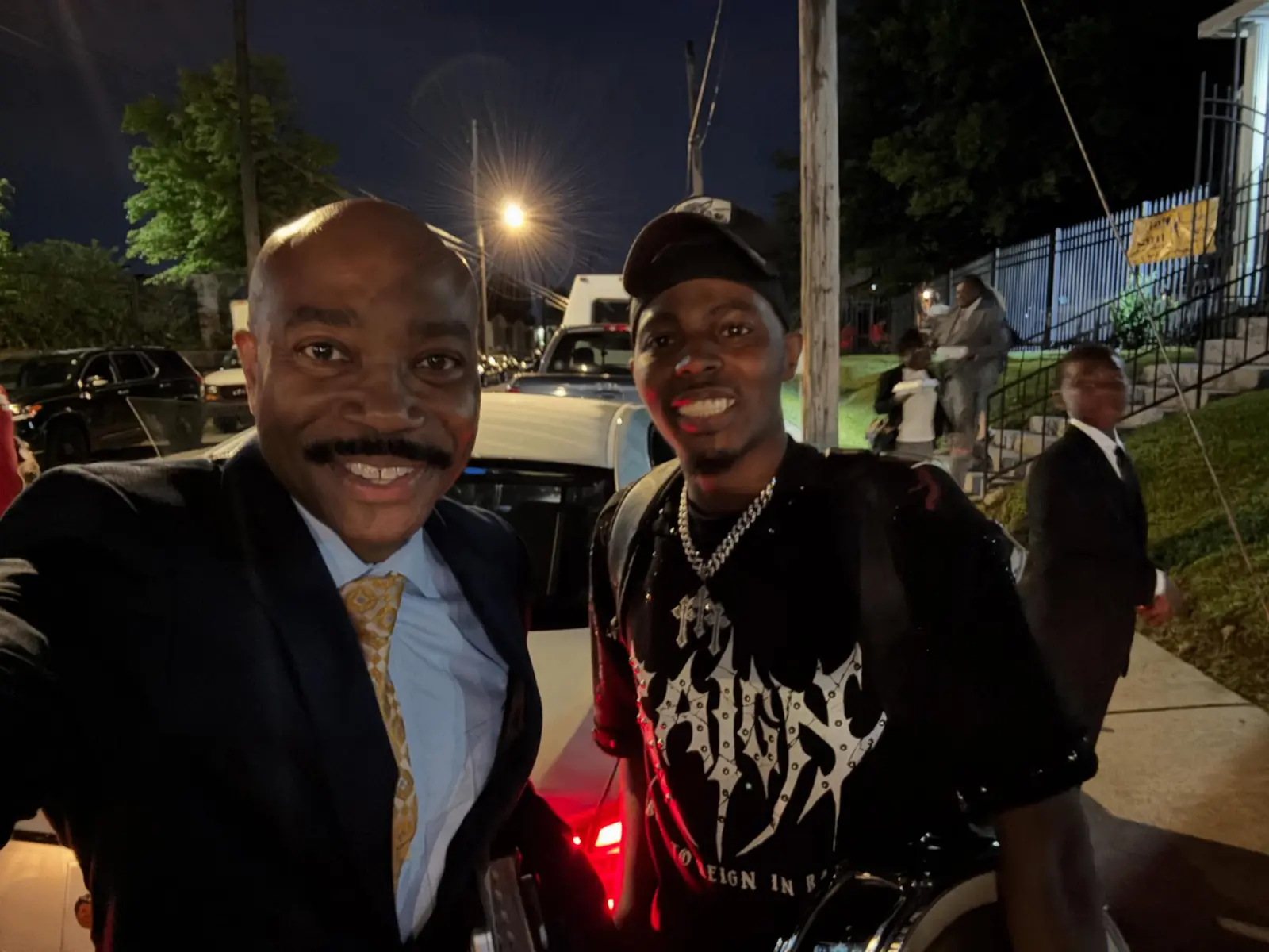 Pastor taking a selfie outdoors with a young adult after church