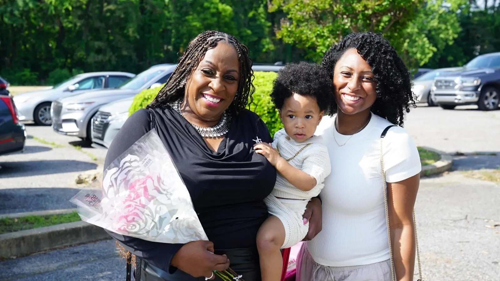Grandmother, mother, and baby smiling together after service