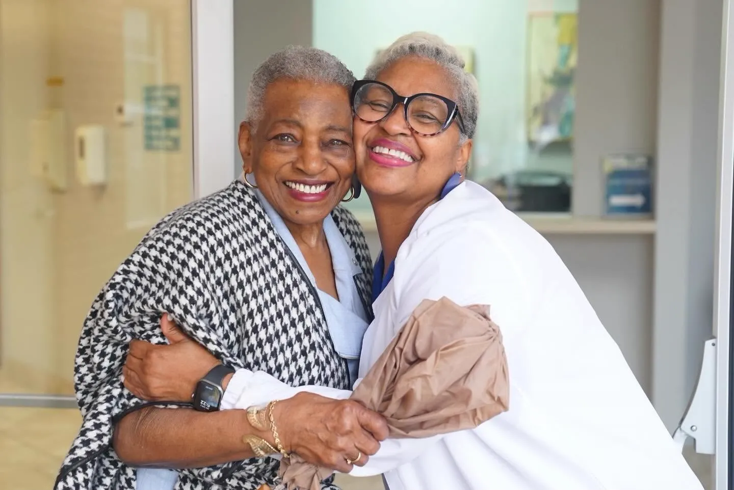 Two church mothers sharing a warm hug