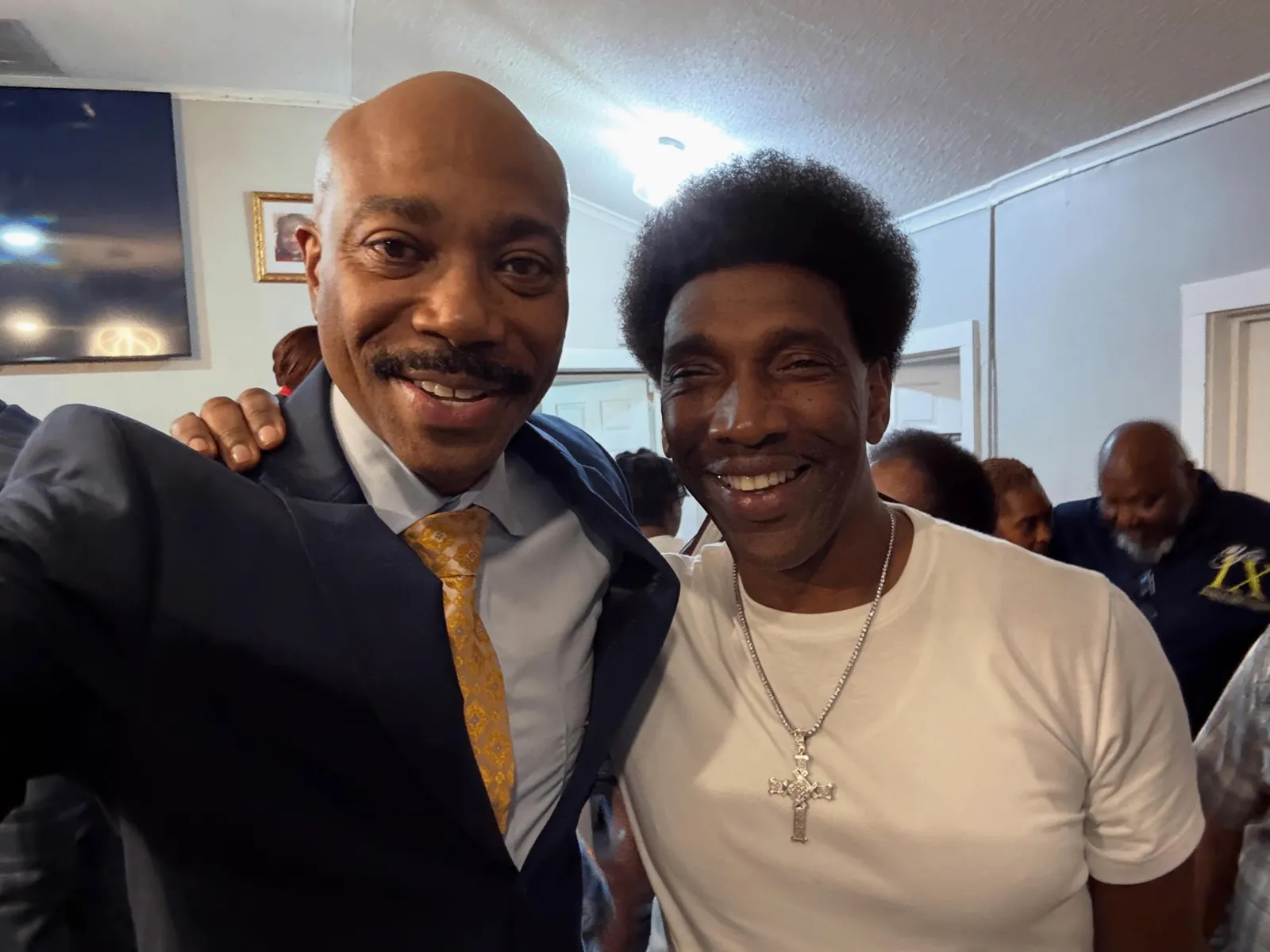 Pastor smiling in a selfie with a member after service